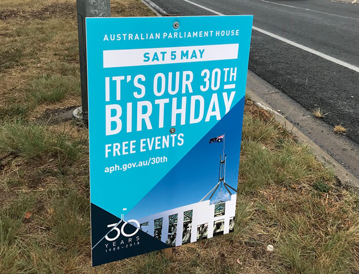 Road signage promoting an event at Parliament House using the 30 years brand identity.